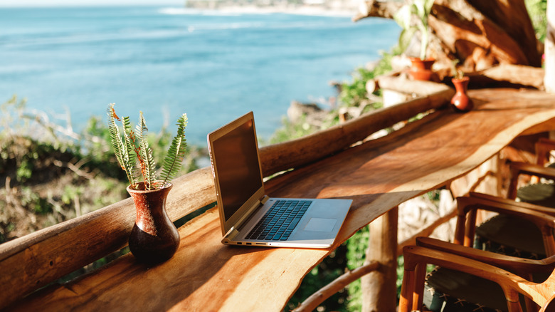 laptop on long wooden table