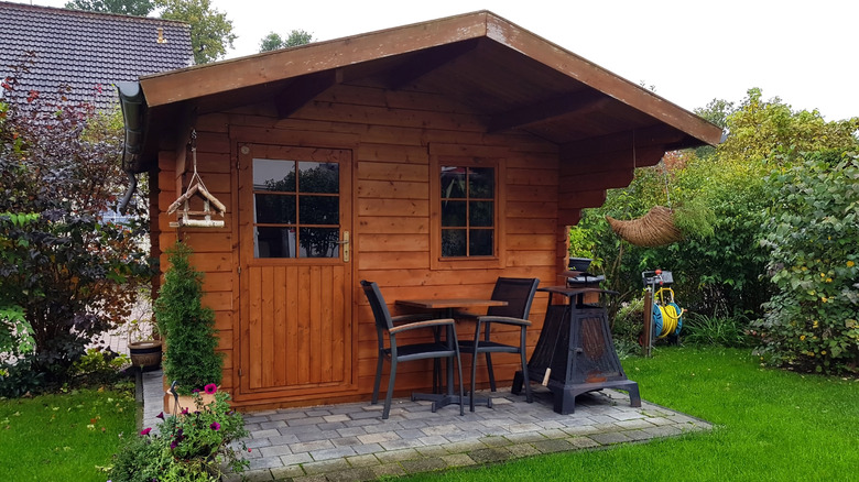 small wooden cabin in backyard