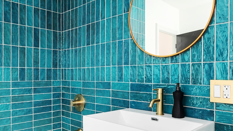 Teal tiled bathroom walls