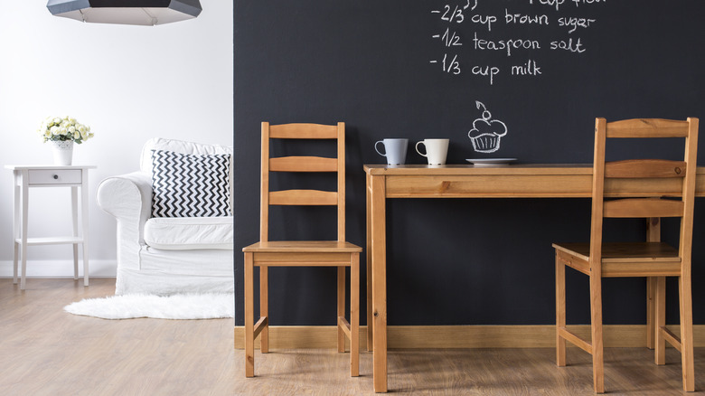 dining room with a chalkboard accent wall