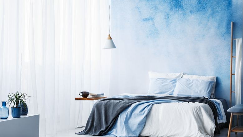 Bedroom with cloud painted wall
