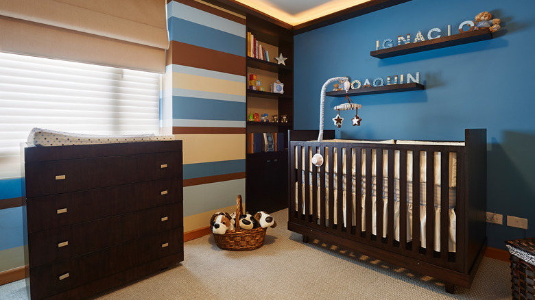 blue nursery with dark wood furniture