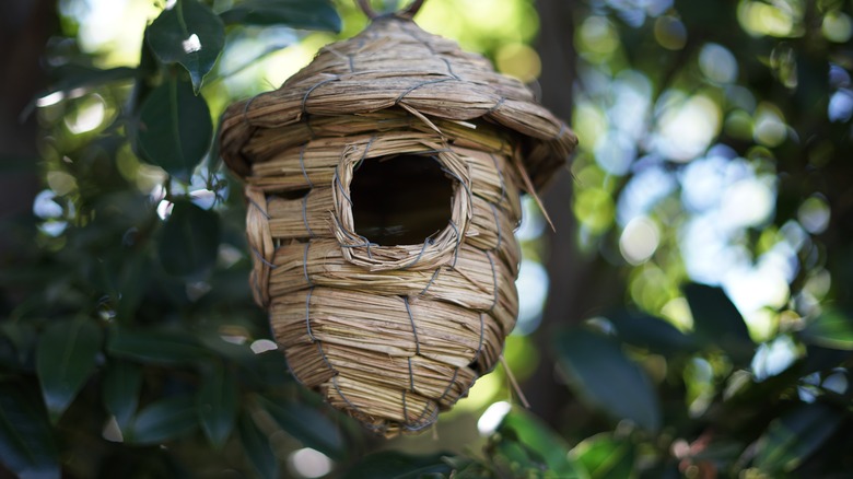 a woven straw birdhouse