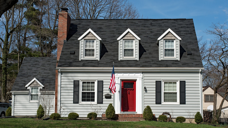 cape cod style house with red front door