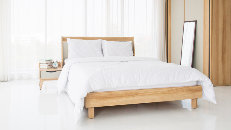 wood bed frame in bedroom
