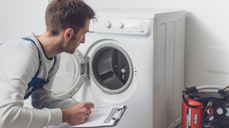 Contractor checking washing machine