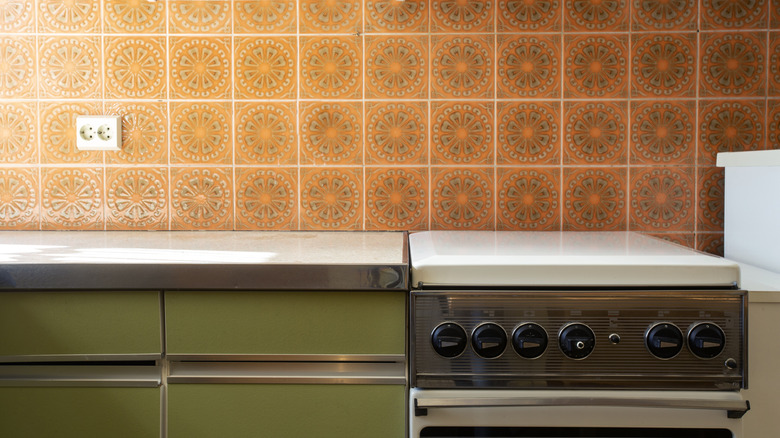 green cabinets with orange backsplash