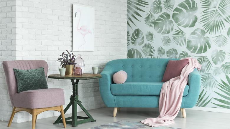 pastel furniture against leafy wallpaper