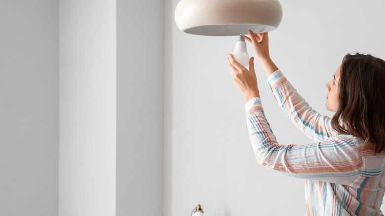 woman Changing a light bulb