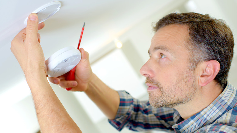 man Installing a smoke detector