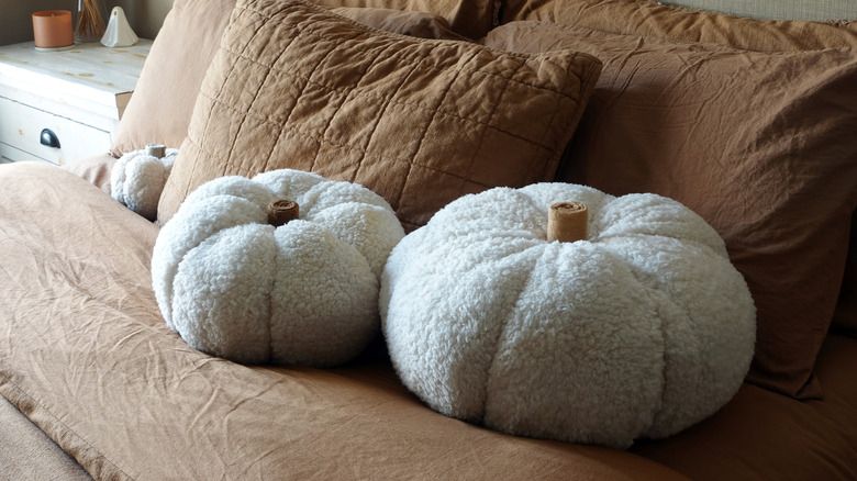 Pumpkin pillows on a bed