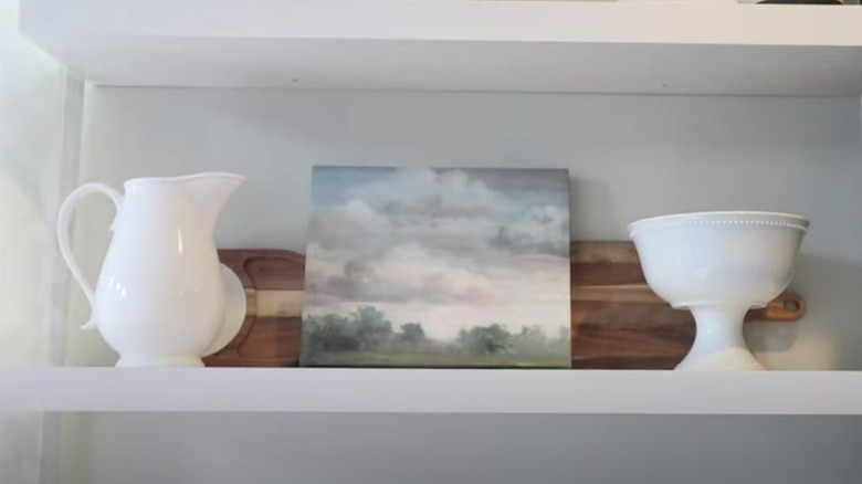 artwork on white open shelving