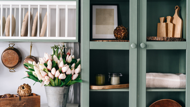 framed artwork in glass cupboard