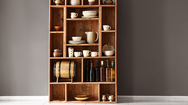 dishes in open wooden cabinet