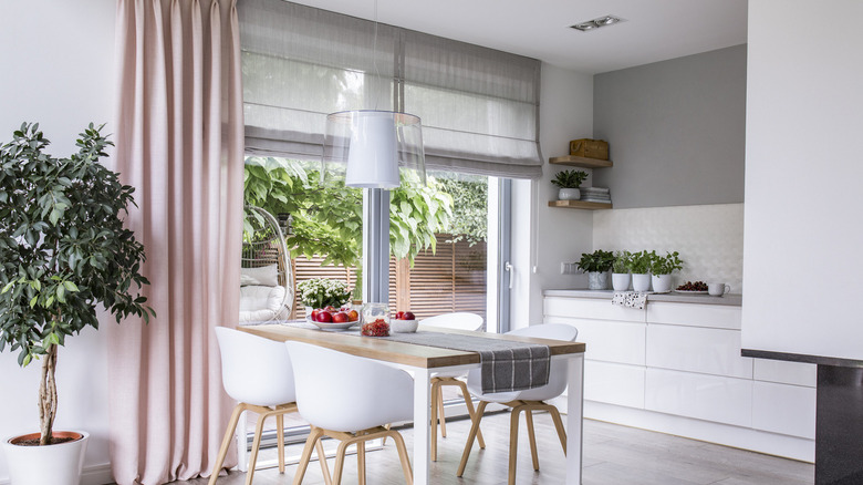 White kitchen with pink curtains 