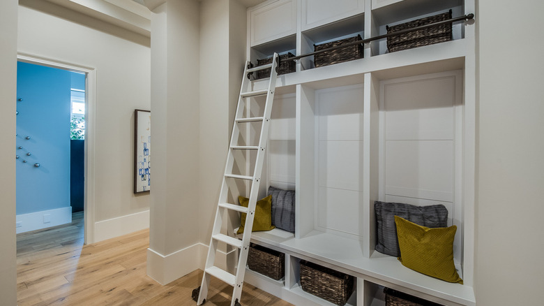 decorated mudroom with ladder