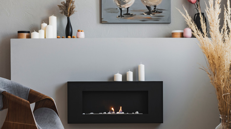 Candles placed above fireplace