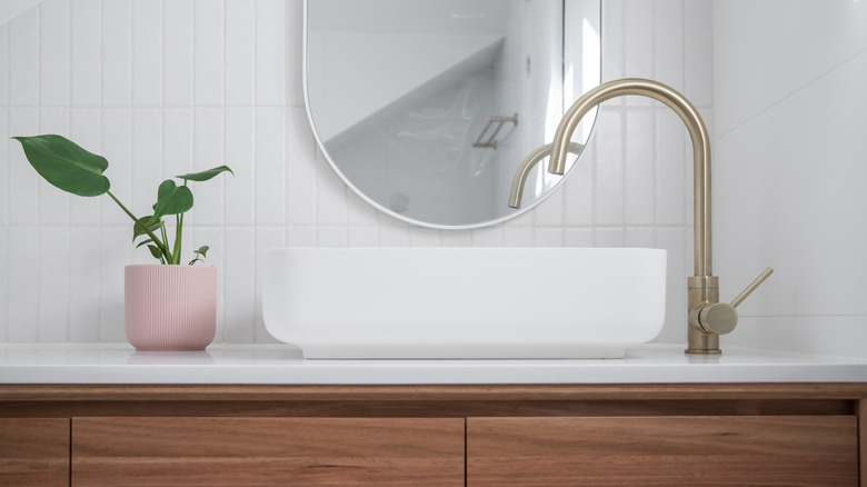 pink vase on bathroom counter