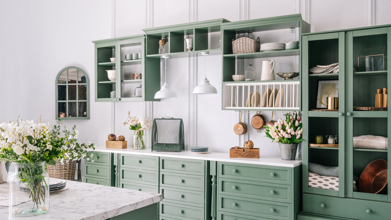 green kitchen cabinets below ceiling