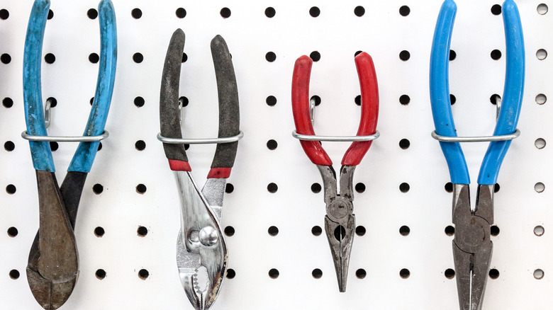 Pliers hanging on pegboard