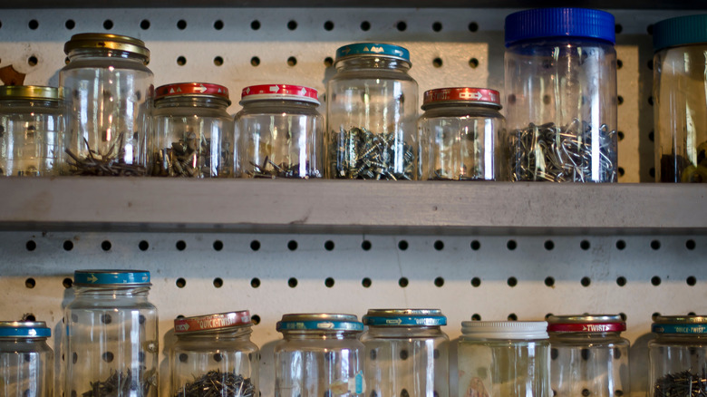 Old jars storing screws and nails