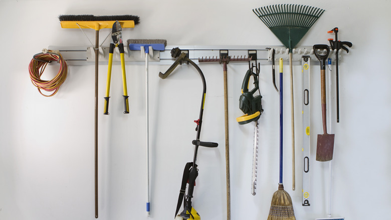 Lawn tools on wall mounted organizer