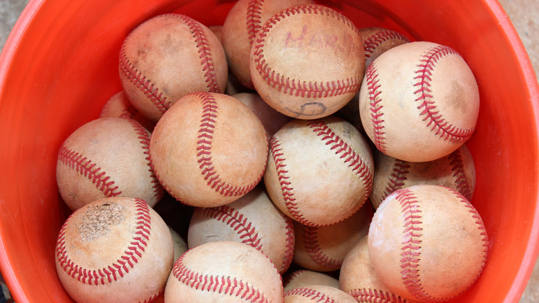 Baseballs in red bucket