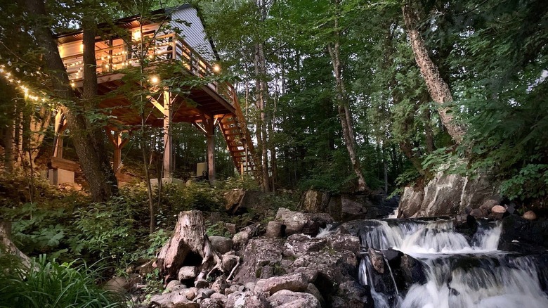 treehouse sitting above a waterfall