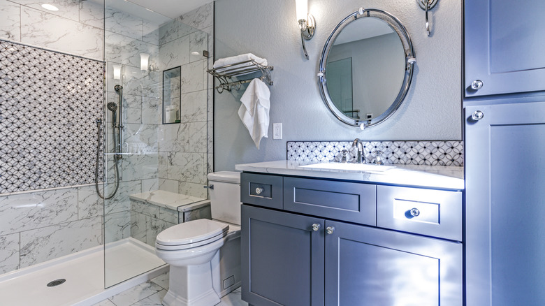 white bathroom with blue cupboards