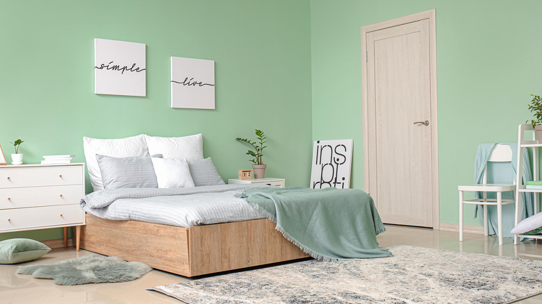 mint green bedroom with black furniture