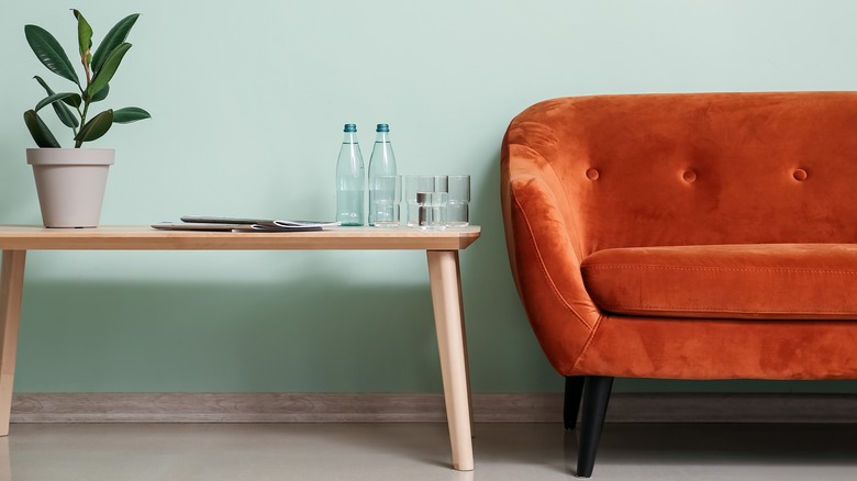 orange couch in mint room