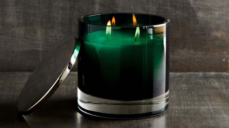 Lit green scented candle