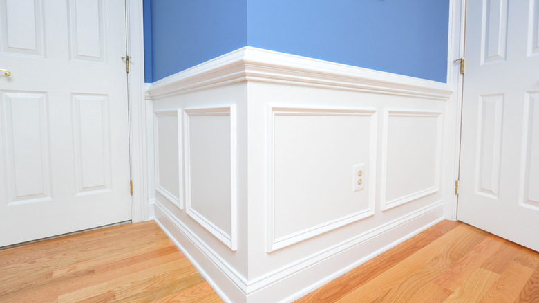 white wainscoting on blue wall