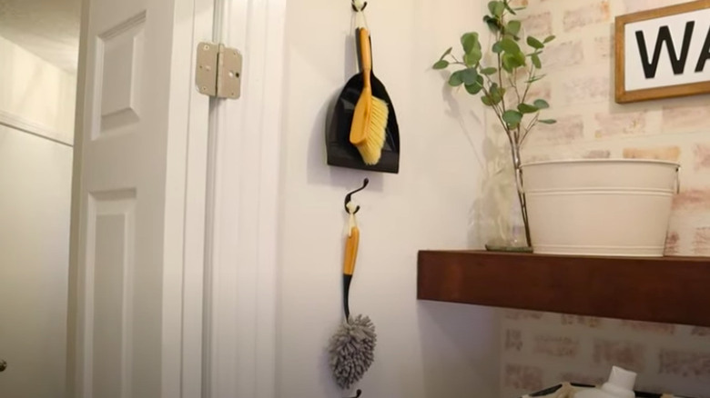 Cleaning tools hanging on hooks