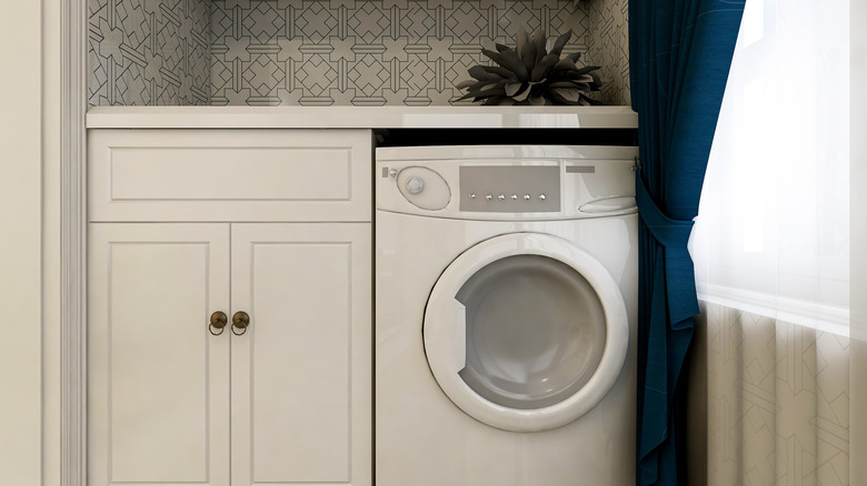 Washer and dryer combo with white cabinets
