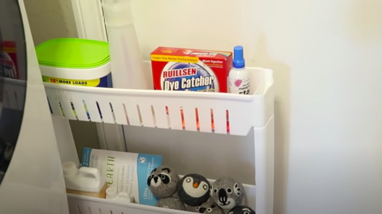 Narrow white rolling laundry cart