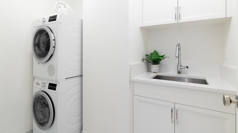 Stacked washer and dryer in white laundry room