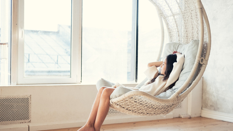 girl relaxing on comfortable hanging chair