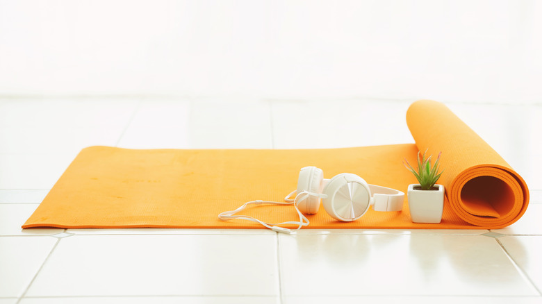 orange yoga mat on tile