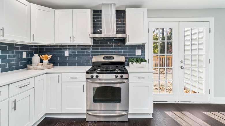 blue backsplash with white cabinets