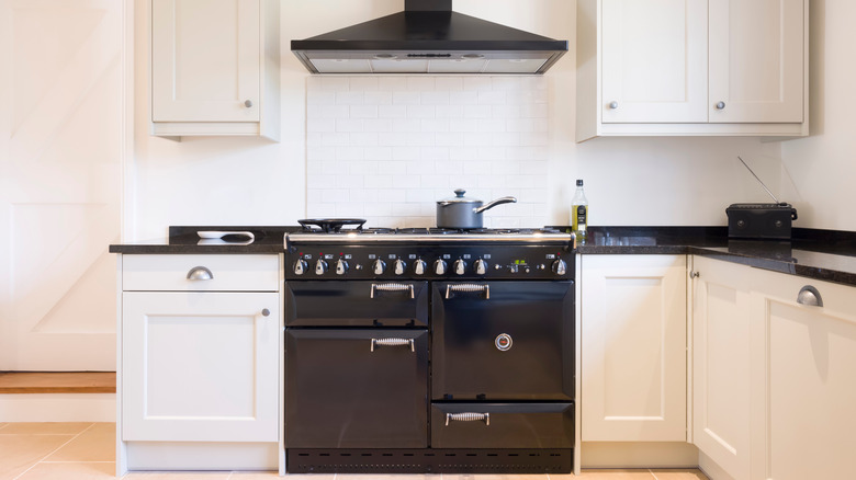 white backsplash above black stove