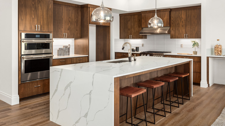 white backsplash with marble island