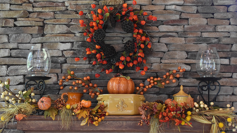 Ceramic pumpkins and fall wreath on mantel