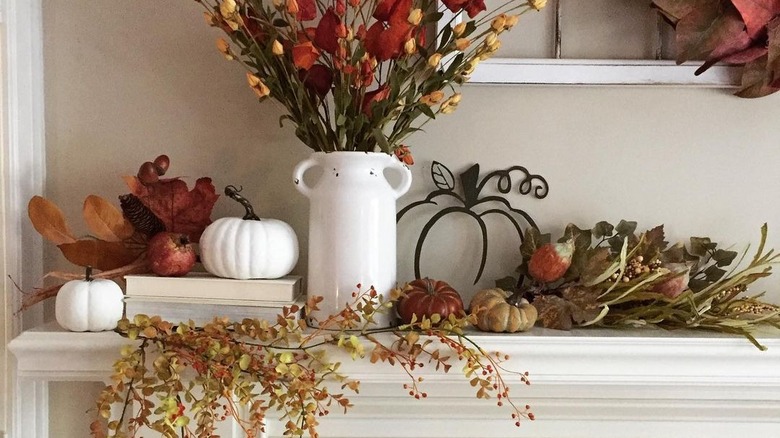 Dried flowers with white ceramic on mantel