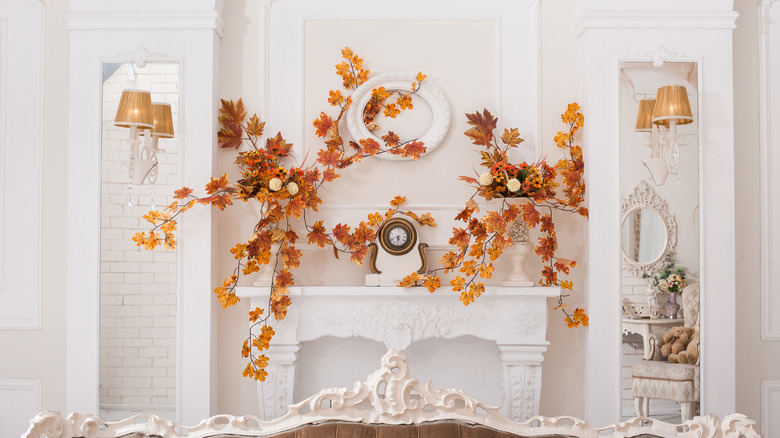 Orange leaves on white fireplace