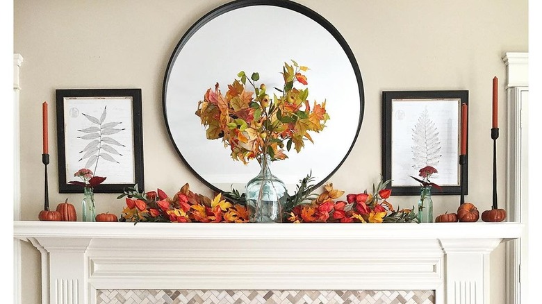 Leaves on mantel with large mirror