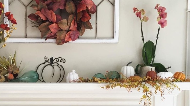 Mantel with orchid and pumpkins