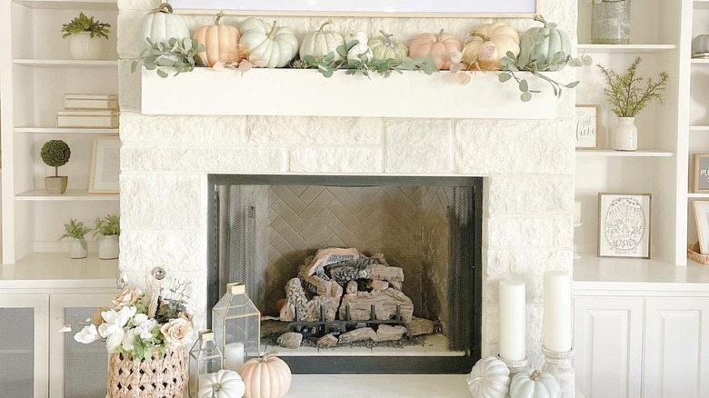 Pastel pumpkins on white mantel