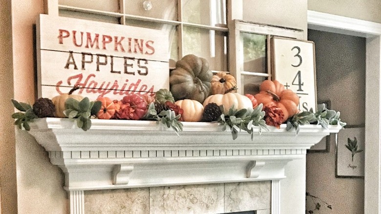 Mantel with pumpkins and pinecones