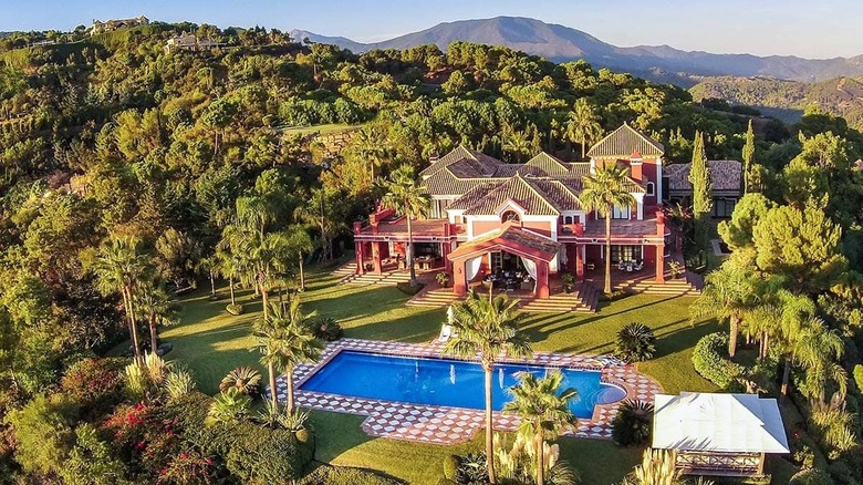 red mansion in the trees